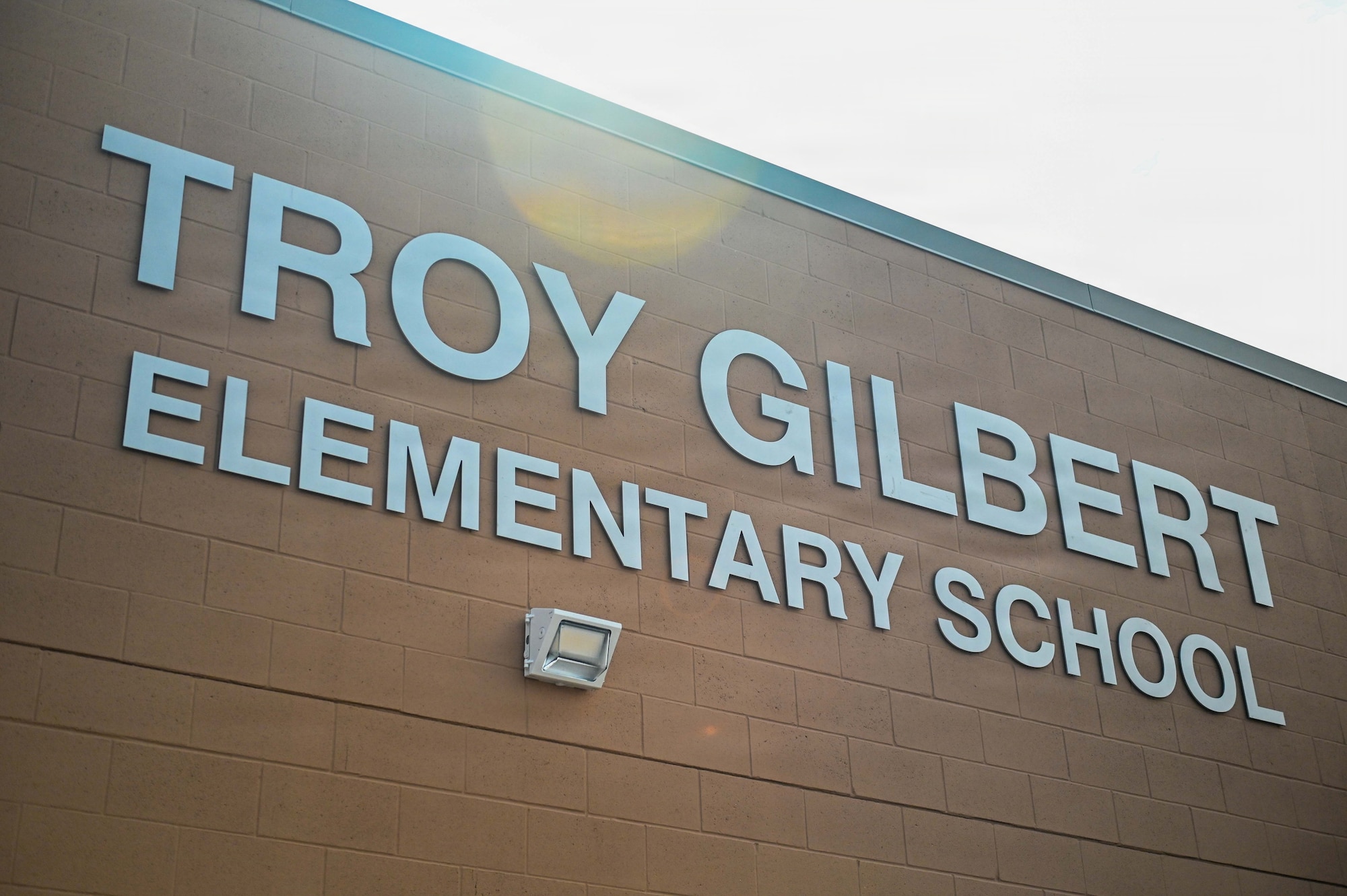 The entrance sign for Troy Gilbert Elementary School is displayed during its ribbon-cutting ceremony in Waddell, Arizona, Aug. 28, 2026. Naming the school in Gilbert's honor extended the connection he has with Luke Air Force Base into the surrounding community, presenting an opportunity for young students to learn more about the U.S. Air Force and its core values. (U.S. Air Force photo by Senior Airman Albert Morel)