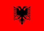 Flag depicting a silhouetted black double-headed eagle in the center of a blood-red field.