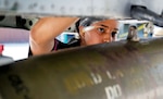 U.S. Air Force Staff Sgt. Kenyah Smith, 25th Fighter Generation Squadron weapons load crew member, inspects munitions during a weapons load crew competition at Osan Air Base, Republic of Korea.