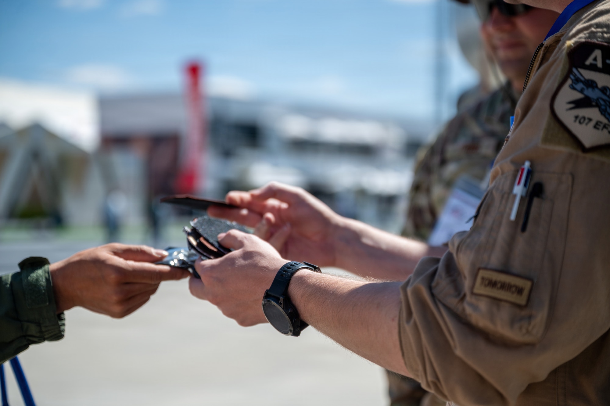 People exchange patches during an airshow