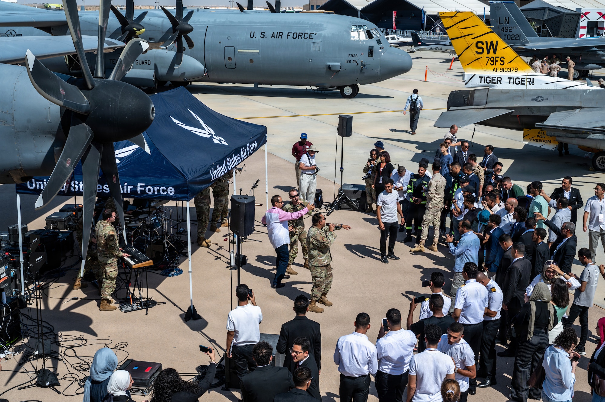 People watch a concert during an airshow