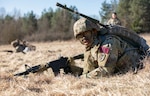 U.S. Army Pfc. Anthony Concepcion, assigned to Dental Health Command Europe, reacts to contact while completing an Expert Field Medical Badge lane during Medical Readiness Command, Europe’s 2025 Best Leader Competition at Grafenwoehr Training Area, Bavaria, Germany.