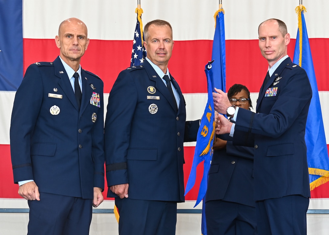 U.S. Air Force Maj. Gen. Ty Neuman, Eighth Air Force and Joint-Global Strike Operations Center commander, center, Col. Erick Lord, 28th Bomb Wing commander, left, and Lt. Col. Joshua Dawkins, B-21 Integration Detachment 1 commander, pose for a photo