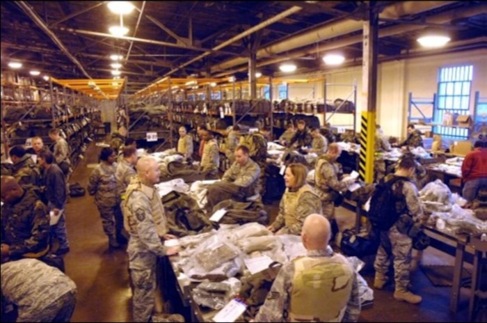 People in a warehouse packing things