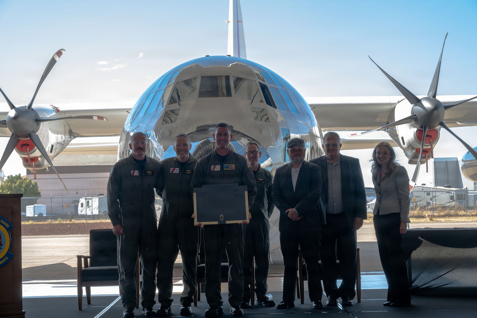 Vice Adm. Joseph R. Buzzella, commander, Coast Guard Pacific Area, and distinguished guests pose for a photo during a delivery ceremony at Coast Guard Air Station Sacramento in McClellan Park, California, Sept. 10, 2026. The Coast Guard commemorated the delivery of the first HC-130J Super Hercules aircraft to Air Station Sacramento. (U.S. Coast Guard photo by Petty Officer 3rd Class Joel LaVallee)