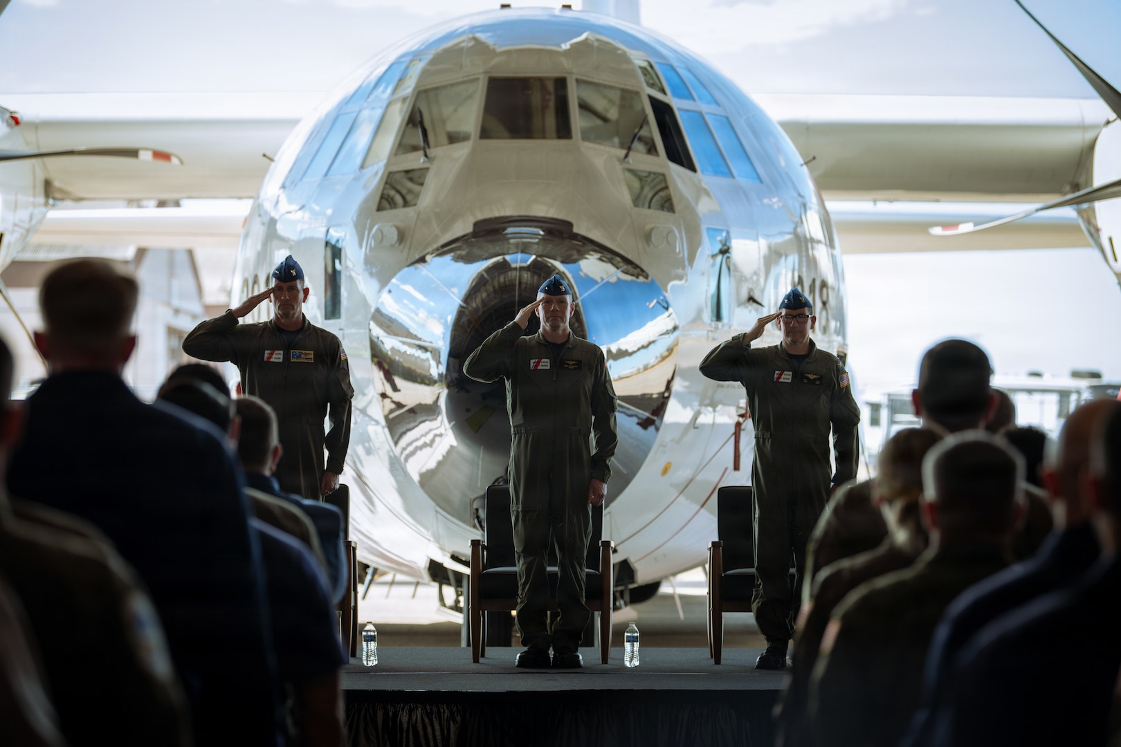 U.S. Coast Guard Vice. Adm. Joseph Buzzella, commander of Coast Guard Pacific Area and Defense Forces West, Rear Adm. Tad Wilson, Assistant Commandant for Aviation (CG-AIR), and Capt. Patrick Dill, commanding officer of Coast Guard Air Station Sacramento, render a salute during a ceremony at the air station in McClellan Park, California, Sept. 10, 2026. The Coast Guard commemorated the delivery of the first HC 130J Super Hercules aircraft to Air Station Sacramento during the ceremony. (U.S. Coast Guard photo by Petty Officer 3rd Class Kenneth Wiese)