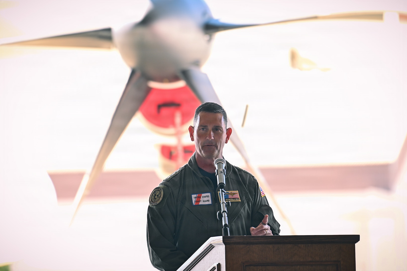 U.S. Coast Guard Vice. Adm. Joseph Buzzella, commander of Coast Guard Pacific Area and Defense Forces West, delivers remarks during a ceremony at the air station in McClellan Park, California, Sept. 10, 2026. The Coast Guard commemorated the delivery of the first HC 130J Super Hercules aircraft to Air Station Sacramento during the ceremony. (U.S. Coast Guard photo by Petty Officer 3rd Class Kenneth Wiese)