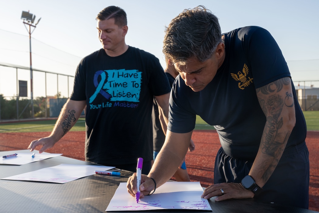 Command Master Chief Jans Valdespou, Naval Support Activity Souda Bay, signs a proclamation in honor of Suicide Prevention Awareness Month after a yoga session onboard NSA Souda Bay, Sept. 1, 2026.