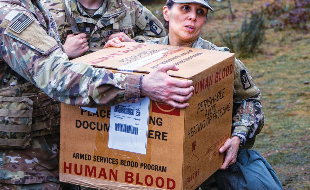 U.S. Army Soldiers assigned to the 62nd Medical Brigade participate in a field training exercise, coordinating the movement of blood supplies during medical operations at Joint Base Lewis-McChord, Washington.