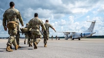 U.S. Air Force medics assigned to the 31st Air Task Force perform a litter carry to a C-146A Wolfhound during a medical evacuation exercise at Hurlburt Field, Florida, Aug. 6, 2026. The training tested their ability to adapt to unknown conditions to provide the best medical care to wounded personnel. (U.S. Air Force photo by Senior Airman Isabel Tanner)