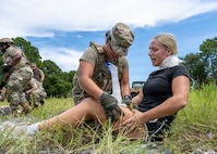 A U.S. Air Force medic assigned to the 31st Air Task Force simulates treating a patient during a mass casualty exercise at Hurlburt Field, Florida, Aug. 4, 2026. The week of training combined instruction from subject matter experts with dramatized, hands-on scenarios, preparing medics for the challenges of operating downrange. (U.S. Air Force photo by Senior Airman Isabel Tanner)