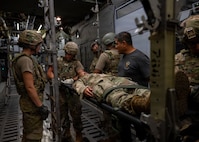 U.S. Special Operations Forces Medical Element personnel instruct medics assigned to the 31st Air Task Force on casualty evacuation aboard an MC-130 fuselage trainer at Hurlburt Field, Florida, Aug. 4, 2026. The 31st ATF teamed with the 1st Special Operations Medical Group and the 492nd Special Operations Wing to create realistic training environments for its medical professionals. (U.S. Air Force photo by Senior Airman Isabel Tanner)