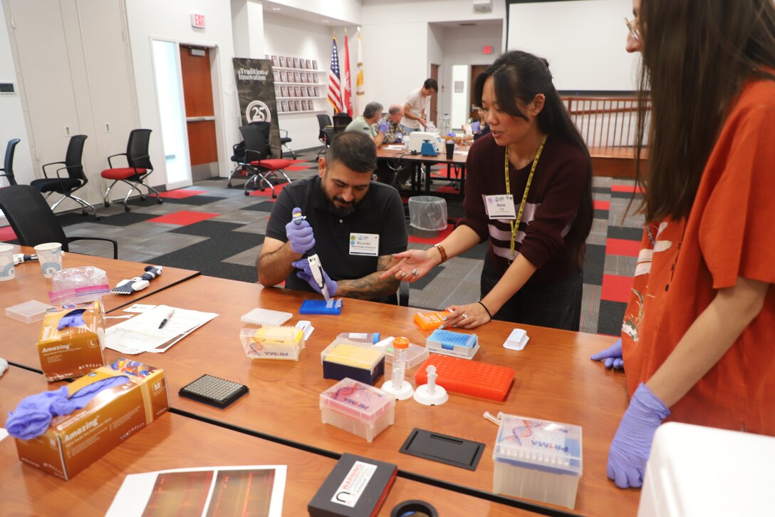 Workshop instructors and members of ERDC-CERL’s Threatened and Endangered Species team, Renee Tam and Lauren Urie, conduct a demonstration on pipetting, a critical part of the environmental DNA (eDNA) process.