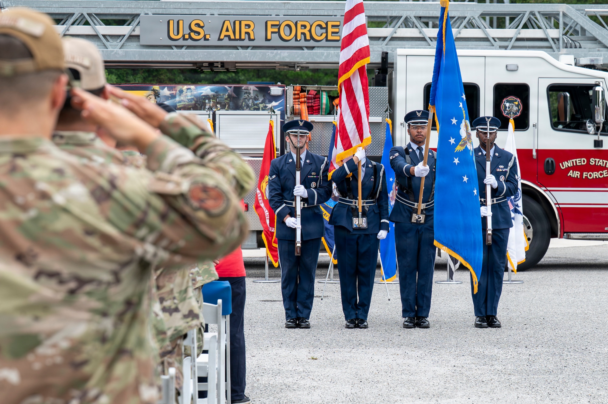 A photo of service members honoring the national anthem during a 09/11 Remembrance Ceremony.