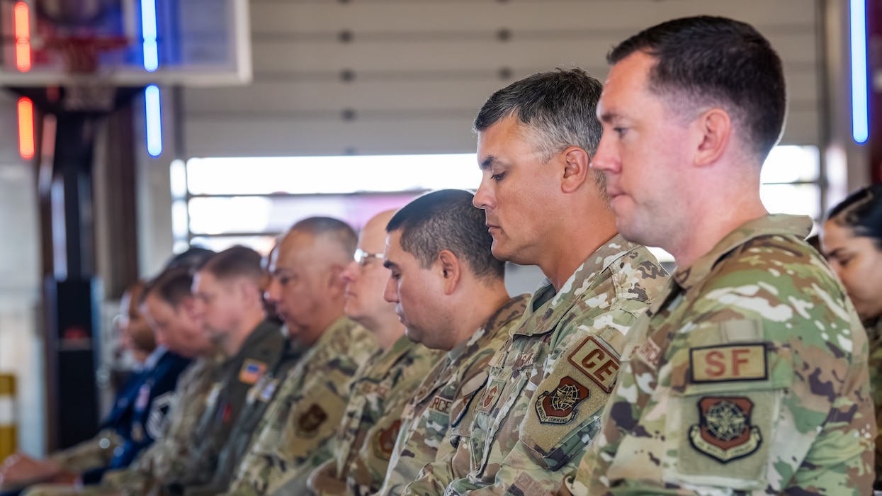 Airman bow heads during a moment of silence