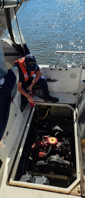 U.S. Coast Guard Petty Officer 2nd Class Alec Dunn, a boatswains mate assigned to Coast Guard Station Grand Haven, extinguishes a fire aboard a vessel in Lake Michigan Sept. 11, 2026. Dunn utilized a pump and fire extinguisher while standing fire watch as the boat crew towed the vessel back to shore where the passengers were returned to safety. (U.S. Coast Guard photo by Petty Officer 2nd Class Scott Caylor)
