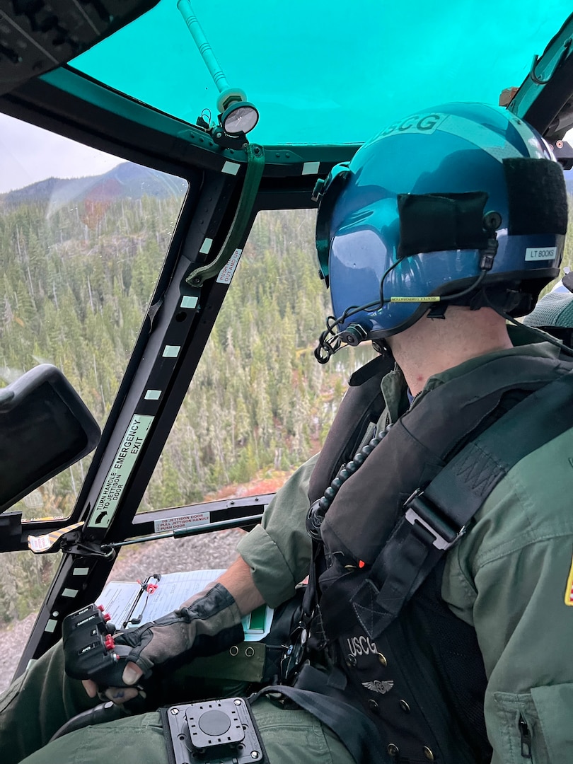Lt. Cmdr. Brandon Books, pilot from Air Station North Bend manipulates the controls of the MH-65 Dolphin near North Sister, Oregon, Saturday, Sept. 5, 2026.