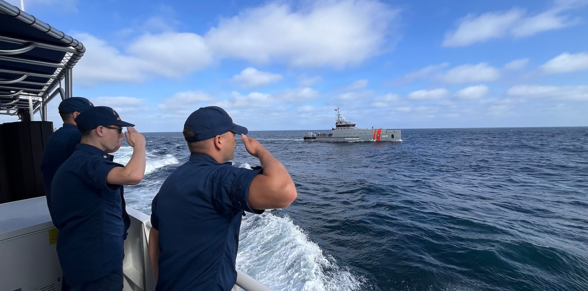 U.S. Coast Guard Ensign Demetrius Gehring and Petty Officer 3rd Class Johnathon Christobal, two crew members assigned to the U.S. Coast Guard Cutter Robert Ward (WPC 1130) a fast response cutter homeported in San Pedro, California, render a salute to Ecuadorian Coast Guard LAE Isla Isabella (LG-31) during a multi-ship leap-frogging exercise off of the Galapagos Islands, August 21, 2026. During the maneuver, as part of a cultural exchange, the crew members of the Robert Ward broadcasted patriotic music over its loudspeakers as a representation of American culture, while partner nation’s vessels played songs representing their own cultures. (U.S. Coast Guard photo by Lt. John Loewenstein)