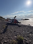 A U.S. Coast Guard Air Station Traverse City MH-60 Jayhawk helicopter sits on the shore of Isle Royale, Michigan, Sept. 11, 2026. The helicopter crew transported Michigan State Police troopers and K-9 units to the island to search for a missing hiker. (U.S. Coast Guard photo, courtesy Air Station Traverse City)