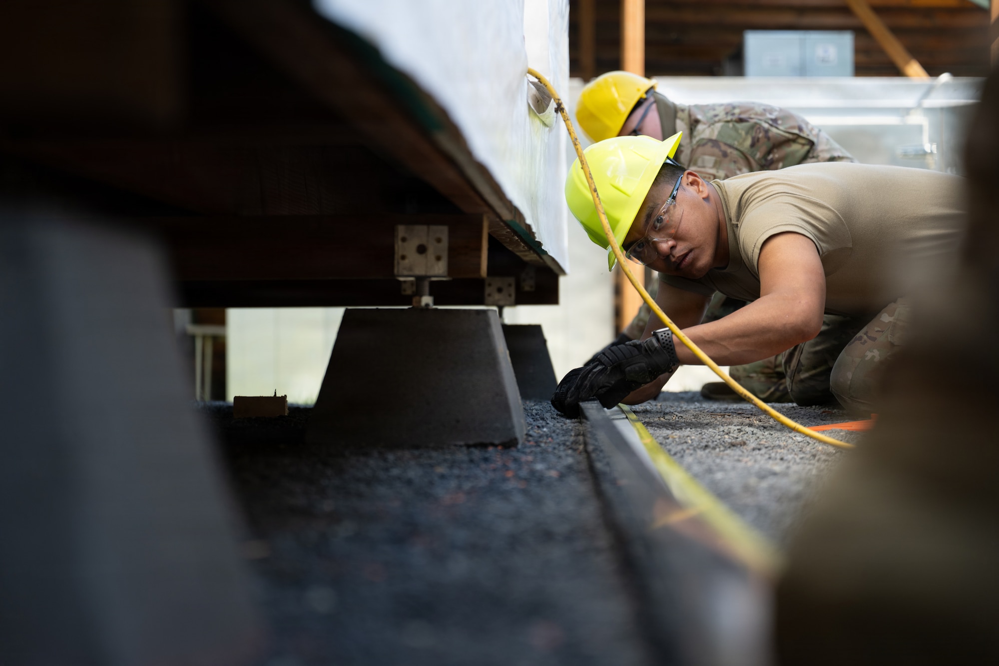 U.S. Airmen assigned to the 163d Civil Engineer Squadron, California Air National Guard, perform upgrade projects during a deployment for training (DFT) at Seward Military Resort in Seward, Alaska, Aug. 10-24, 2026. Thirty-nine Airmen across seven Air Force Specialty Codes participated in the fifth and final rotation of Civil Engineer units from across the country, conducting trenching, metal wrapping, electrical work, concrete placement and roofing across four structures. The DFT allows Airmen to upgrade the Morale, Welfare and Recreation facility while completing training requirements that prepare them to perform their duties in overseas and deployed environments. (U.S. Air National Guard photo by Tech. Sgt. Pagan)