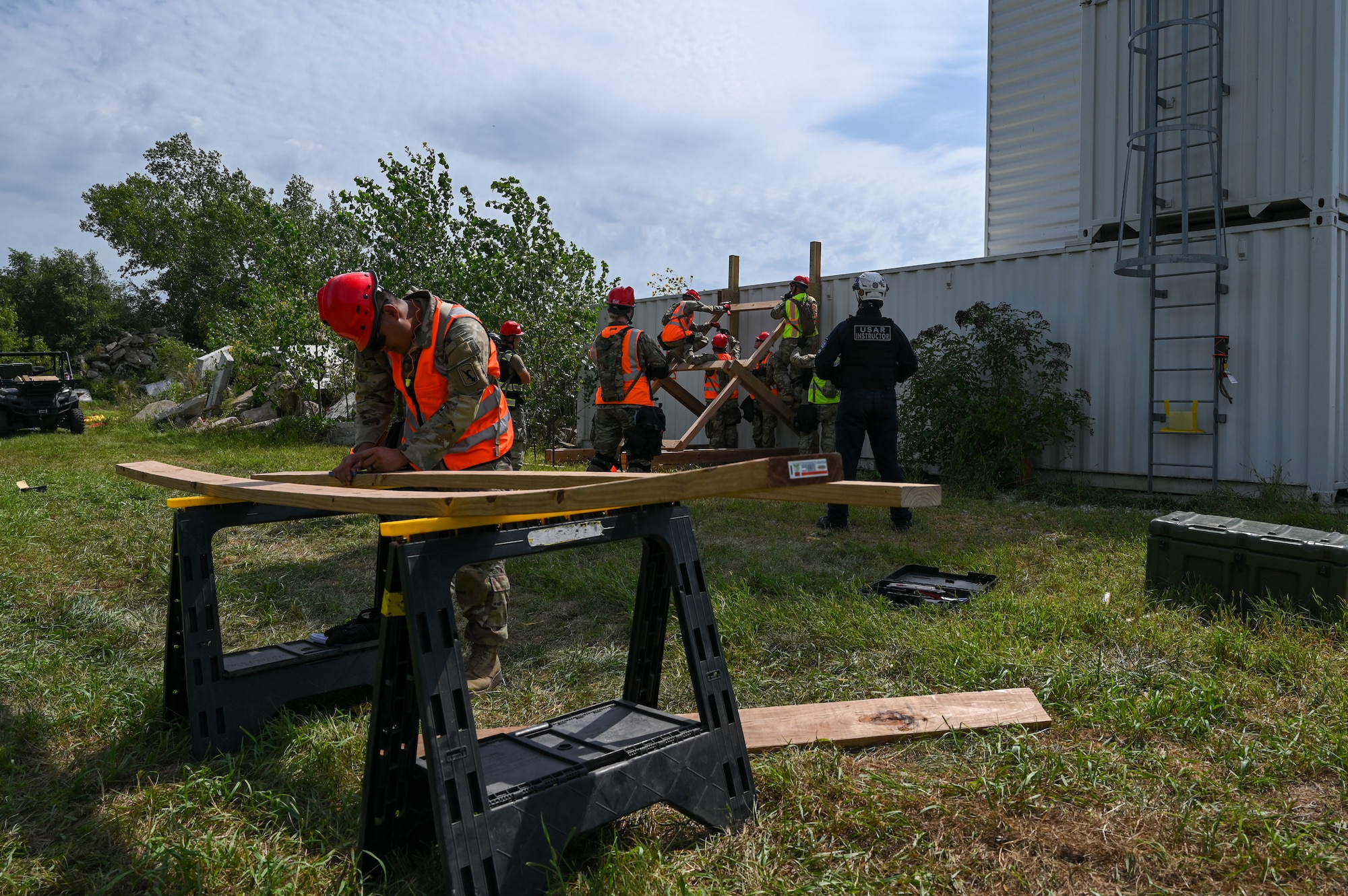 Nebraska Army National Guard Soldiers cut and prepare lumber to construct an alternate entrance to a simulated disaster site during a disaster response exercise in Yutan, Nebraska, Sept. 2, 2026. The training challenged Soldiers to safely create access points into a damaged or obstructed structure, allowing search and extraction teams to reach and recover casualties during a large-scale emergency response.