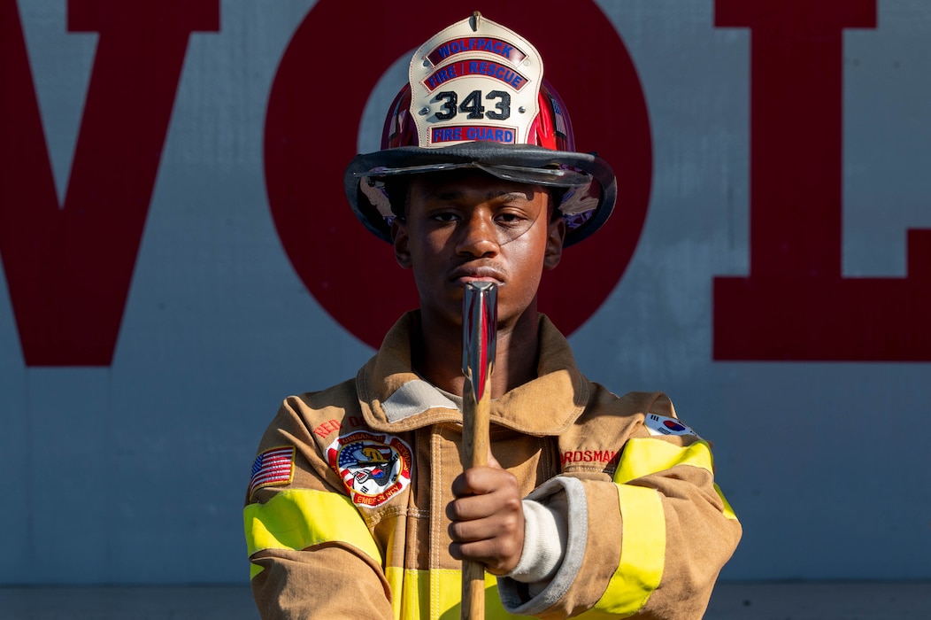 U.S. Air Force Airman 1st Class Cameron Hill, 8th Civil Engineer Squadron firefighter, stands at attention during the presentation of the colors at the 9/11 25th anniversary ceremony at Kunsan Air Base, Republic of Korea, Sept. 11, 2026. The heroic efforts of so many on September 11 serve as an inspiration for the generations of today and tomorrow. (U.S. Air Force photo by Staff Sgt. Cedrique Oldaker)