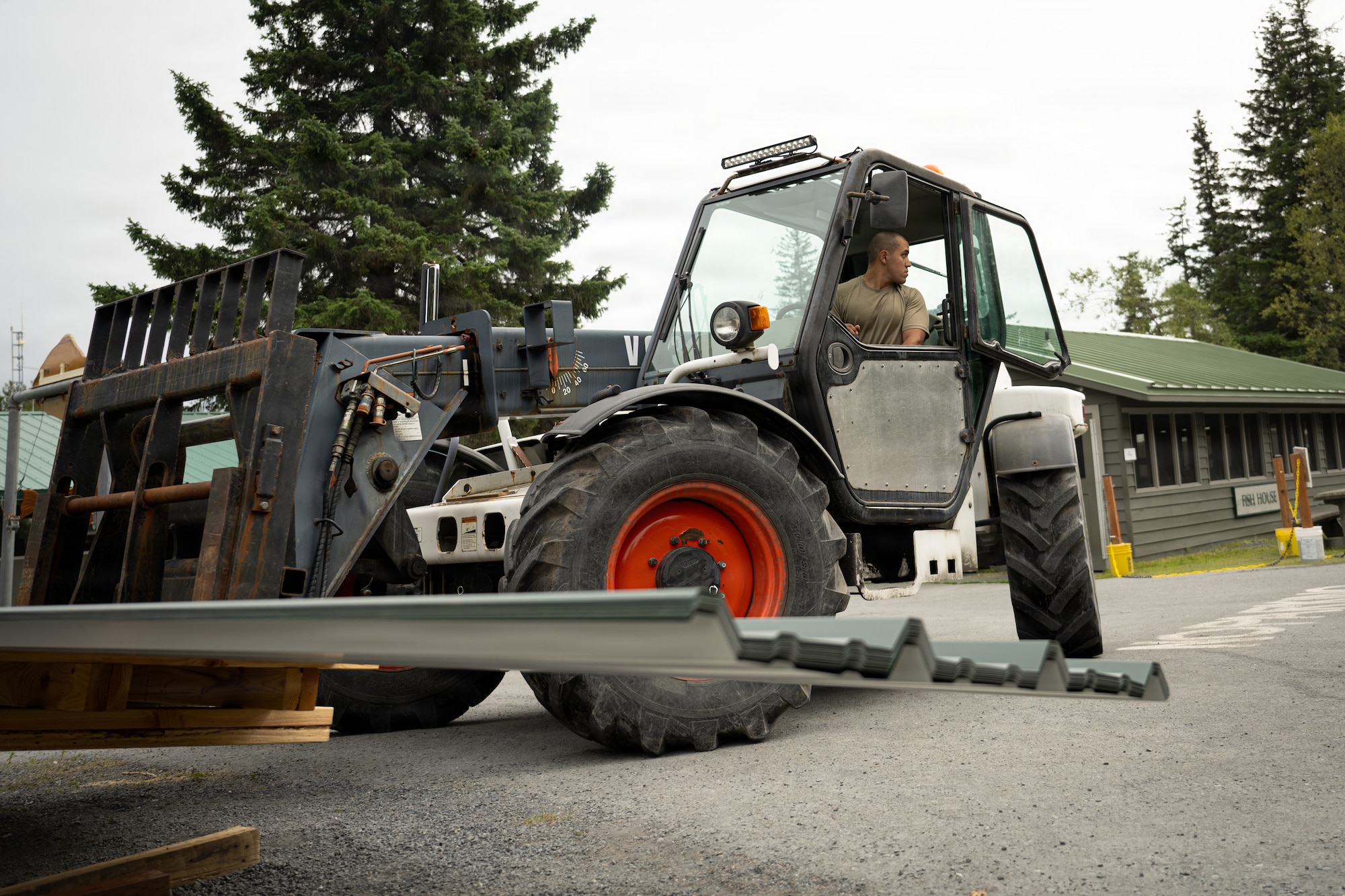U.S. Airmen assigned to the 163d Civil Engineer Squadron, California Air National Guard, perform upgrade projects during a deployment for training (DFT) at Seward Military Resort in Seward, Alaska, Aug. 10-24, 2026. Thirty-nine Airmen across seven Air Force Specialty Codes participated in the fifth and final rotation of Civil Engineer units from across the country, conducting trenching, metal wrapping, electrical work, concrete placement and roofing across four structures. The DFT allows Airmen to upgrade the Morale, Welfare and Recreation facility while completing training requirements that prepare them to perform their duties in overseas and deployed environments. (U.S. Air National Guard photo by Tech. Sgt. Pagan)