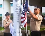 Hospital Corpsman 1st Class Rhyan Capili, right, and Cryptologic Technician (Technical) 1st Class Alexandra Smith, both chief petty officer selectees assigned to Navy Medicine Readiness and Training Command (NMRTC) Okinawa, prepare to hoist the American and Japanese flags during a morning colors ceremony on Camp Foster, Okinawa, Japan, Sept. 11, 2026. The ceremony, coordinated by the command’s chief selectees, commemorated the 25th anniversary of the 9/11 attacks. (U.S. Navy photo by Mass Communication Specialist 1st Class Simon Pike)