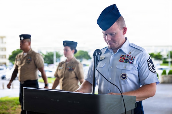 U.S. Air Force Master Sergeant Adam Huey, assigned to Navy Medicine Readiness and Training Command (NMRTC) Okinawa, acts as master of ceremonies during an all-hands morning colors ceremony on Camp Foster, Okinawa, Japan, Sept. 11, 2026. The ceremony, coordinated by the command’s chief selectees, commemorated the 25th anniversary of the 9/11 attacks. (U.S. Navy photo by Mass Communication Specialist 1st Class Simon Pike)