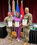 Staff Sgt. Courtney Forbeck, Tori McIntyre, RN, and Staff Sgt. John Maxon, stand together after receiving Certificates of Appreciation during the Volunteer Appreciation Ceremony at Fort Rucker, Alabama, May 28, 2026. The three Lyster Army Health Clinic staff members were recognized for their outstanding off-duty dedication, community service, and commitment to caring for those around them.