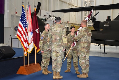 FORT RUCKER, Ala. — U.S. Army Brig. Gen. Jamie Burk, commanding general of Medical Readiness Command, East, receives the guidon from outgoing commander Lt. Col. Leah Steder during the Lyster Army Health Clinic change of command ceremony at the Army Aviation Museum on Fort Rucker, Alabama, July 9, 2026. During the ceremony, Lt. Col. Ryan Allred assumed command of the clinic.