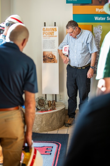 Joe Pintal, Oahe Dam operations program manager, U.S. Army Corps of Engineers, Omaha District, looks at preserved artifacts covered with zebra mussels at the Gavins Point Dam in Yankton, South Dakota, Aug. 26, 2026.