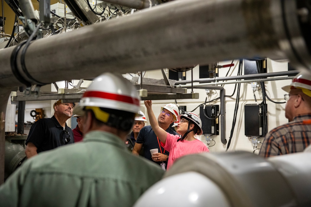 Lacey Gould, electronic mechanic, U.S. Army Corps of Engineers, Omaha District, describes to visitors from the Walla Walla District how the ultraviolet light system along with a molluscicide drip system to combat against invasive zebra mussels at the Gavins Point Dam in Yankton, South Dakota, Aug. 26, 2026.