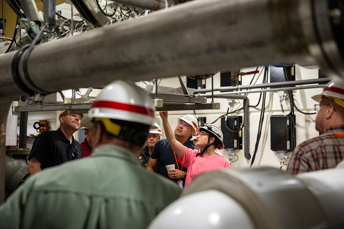 Lacey Gould, electronic mechanic, U.S. Army Corps of Engineers, Omaha District, describes to visitors from the Walla Walla District how the ultraviolet light system along with a molluscicide drip system to combat against invasive zebra mussels at the Gavins Point Dam in Yankton, South Dakota, Aug. 26, 2026.