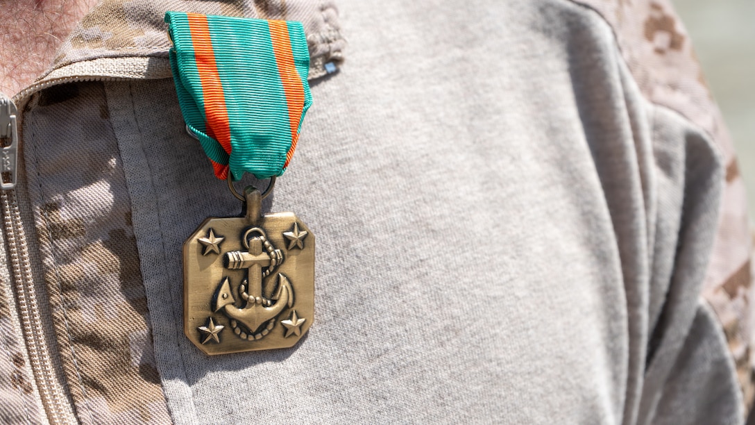 A Navy and Marine Corps Achievement Medal sits on the collar of U.S. Marine Corps Lance Cpl. James Brooks, an infantry rifleman, with  the 1st Battalion, 6th Marine Regiment, 2nd Marine Division, assigned to Joint Task Force-Southern Border (JTF-SB) in support of Operation Ardent Vanguard, the medal was presented during an award ceremony near Campo, California, Aug. 15, 2026. Brooks was presented with the award for saving the life of a suspected illegal alien that was suffering from a heat-related illness. U.S. Northern Command is working side-by-side with the Department of Homeland Security and the U.S. Customs and Border Protection within narrowly defined authorities to provide unique military capabilities to protect the territorial integrity of the U.S. southern border. (Dept. of War photo by Sgt. Nathan Hislop)