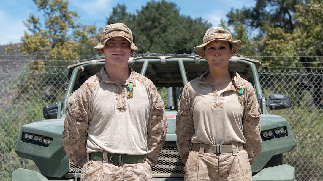 U.S. Marine Corps Lance Cpl. James Brooks, an infantry rifleman, and U.S. Navy Petty Officer 3rd Class Valeria Carmona, a hospital corpsman, both with the 1st Battalion, 6th Marine Regiment, 2nd Marine Division, assigned to Joint Task Force-Southern Border (JTF-SB) in support of Operation Ardent Vanguard, pose for a photo after being awarded the Navy and Marine Corps Achievement Medal near Campo, California, Aug. 15, 2026.  Brooks and Carmona were presented with the award for saving the life of an suspected illegal alien that was suffering from a heat-related illness. U.S. Northern Command is working side-by-side with the Department of Homeland Security and the U.S. Customs and Border Protection within narrowly defined authorities to provide unique military capabilities to protect the territorial integrity of the U.S. southern border. (Dept. of War photo by Sgt. Nathan Hislop)