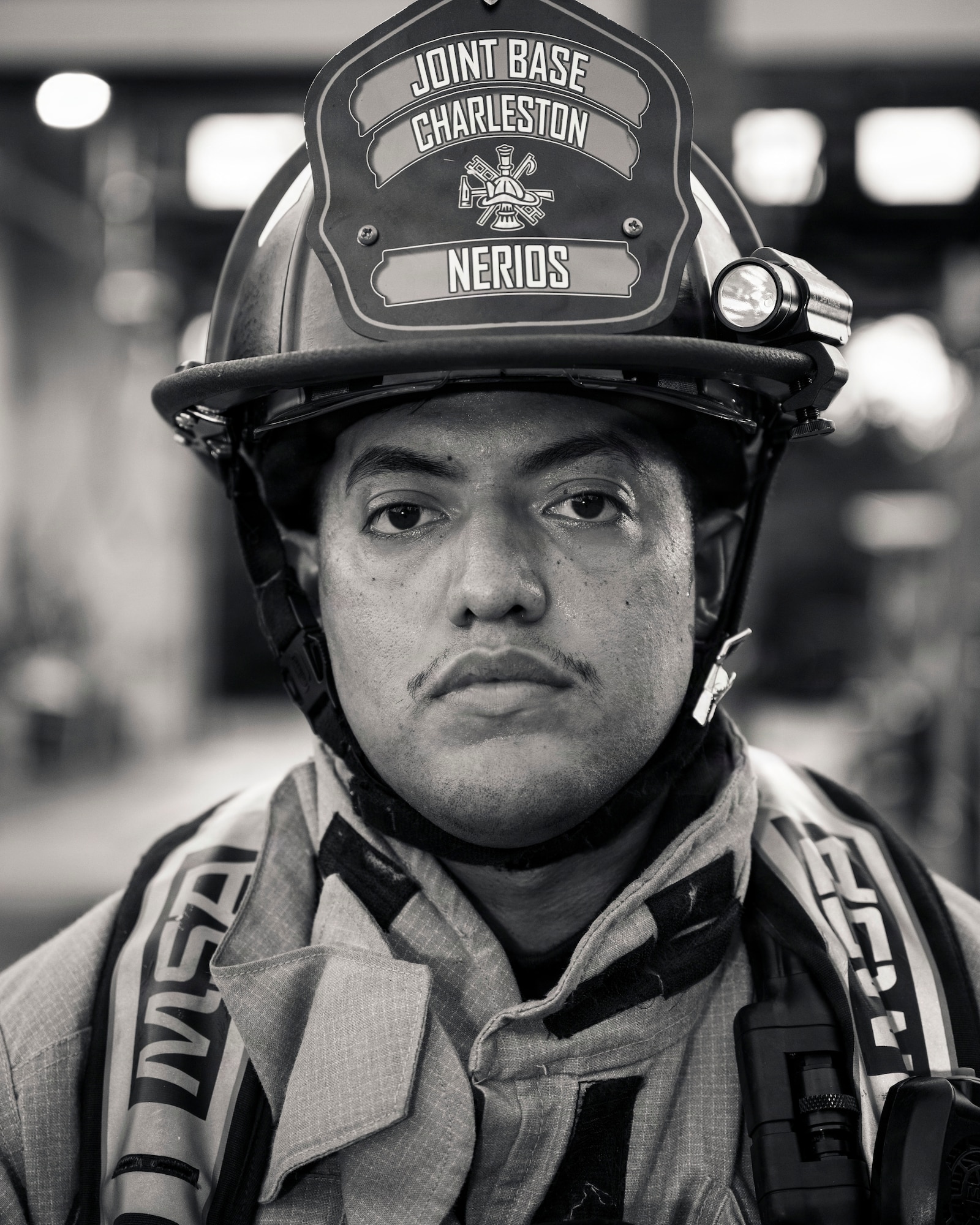 A man un firefighter gear poses for a photo.