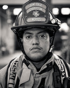 A man un firefighter gear poses for a photo.