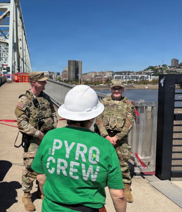 Kentucky National Guard Soldiers with the 617th Military Police Company, 198th Military Police Battalion speak with a member of the pyrotechnics team during their recent mission working with the Newport Police Department for Riverfest 2026 in Newport, Kentucky, Sept. 6, 2026.