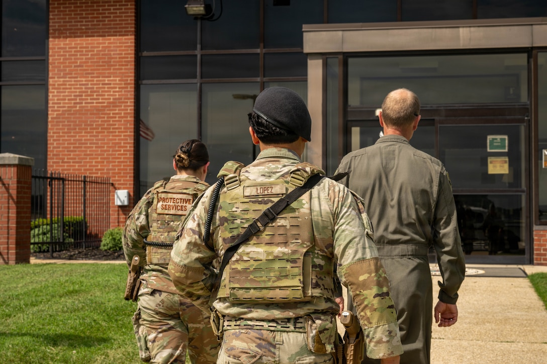 Service members walk into a building together.
