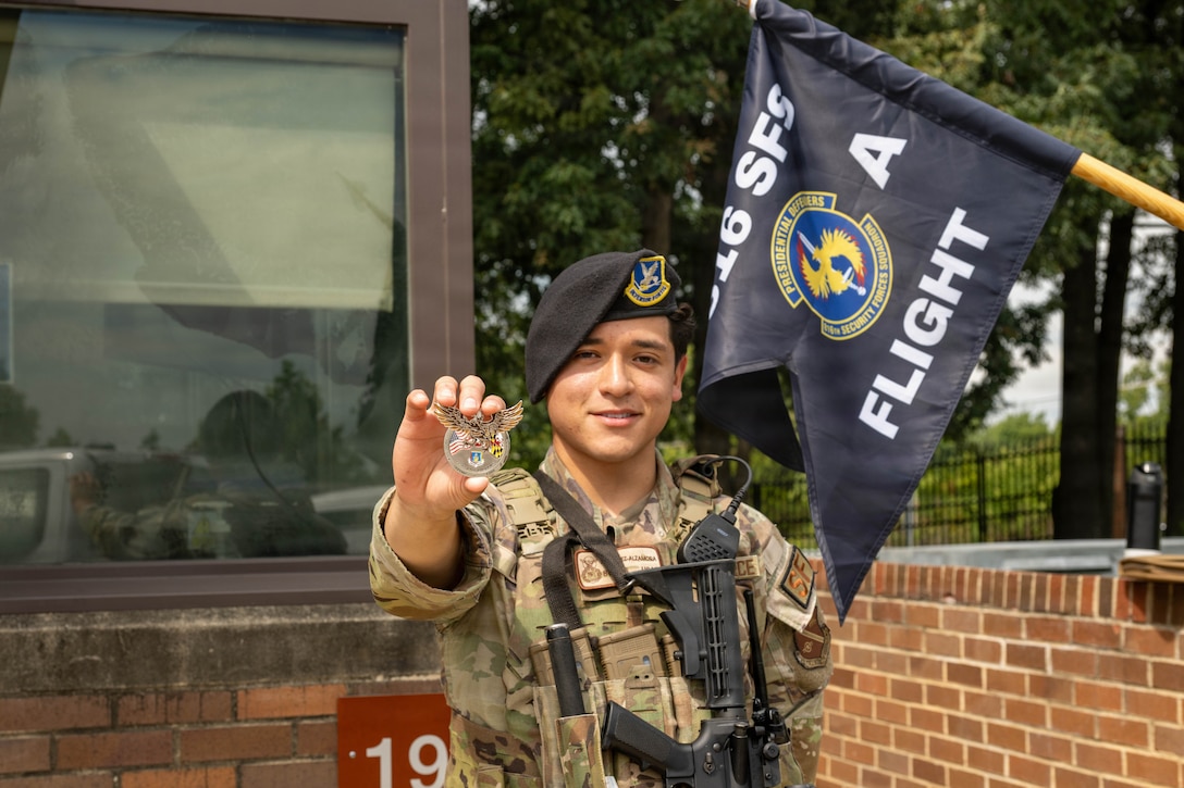 Service member holds a challenge coin.