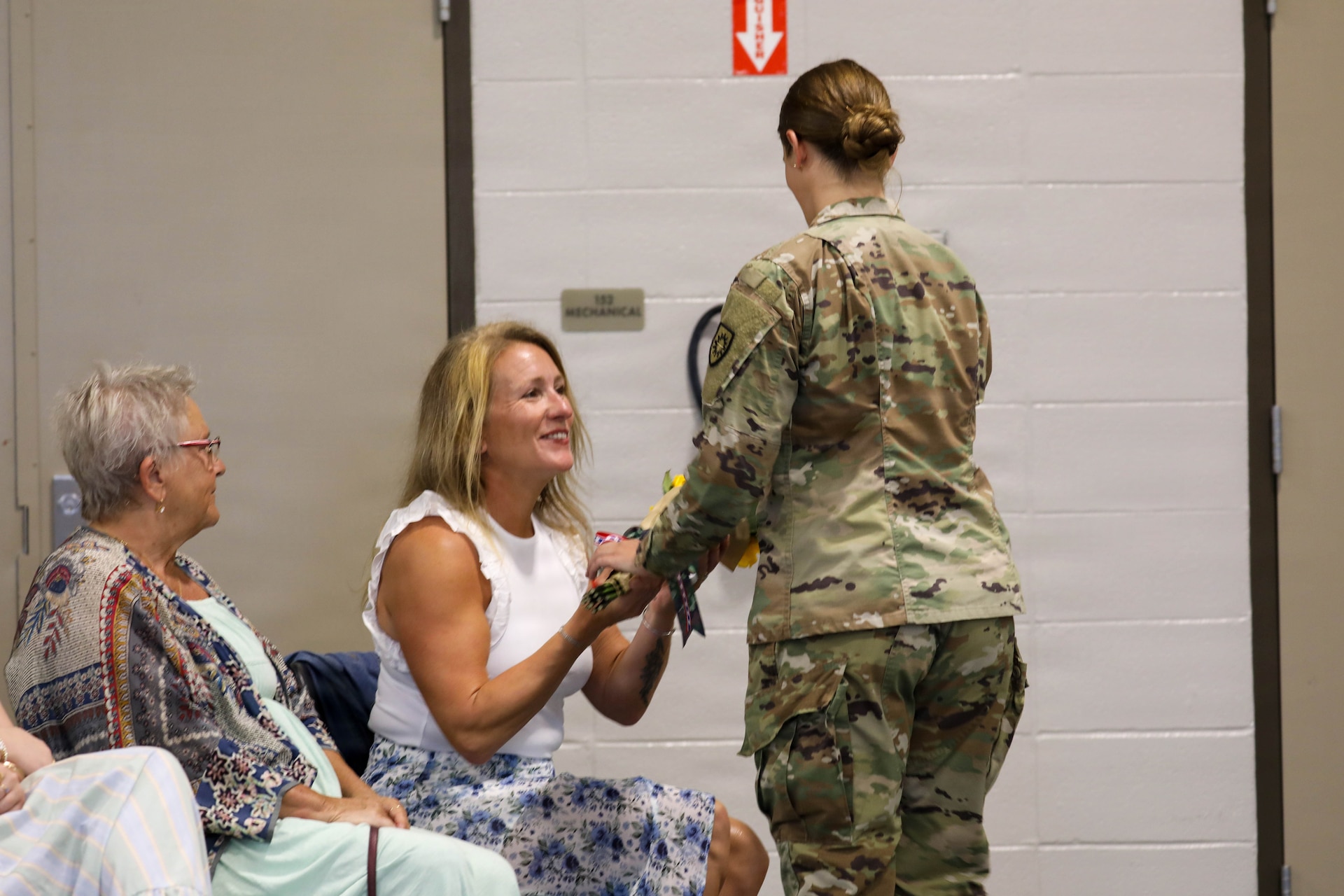 Jennifer, wife of incoming Command Sgt. Maj. Bryan M. Jefferson, is presented with flowers by U.S. Army Sgt. Rachel Townsend, welcoming her to the brigade during a change of responsibility ceremony for Kentucky's 149th Maneuver Enhancement Brigade, held at the Richmond National Guard Armory, Sept. 11, 2026.
