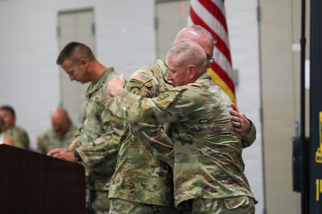 U.S. Army Command Sgt. Maj. Aaron T. Lester, outgoing command sergeant major of Kentucky's 149th Maneuver Enhancement Brigade, embraces incoming Command Sgt. Maj. Bryan M. Jefferson during their change of responsibility ceremony at the National Guard Armory in Richmond, Kentucky, Sept. 11, 2026.