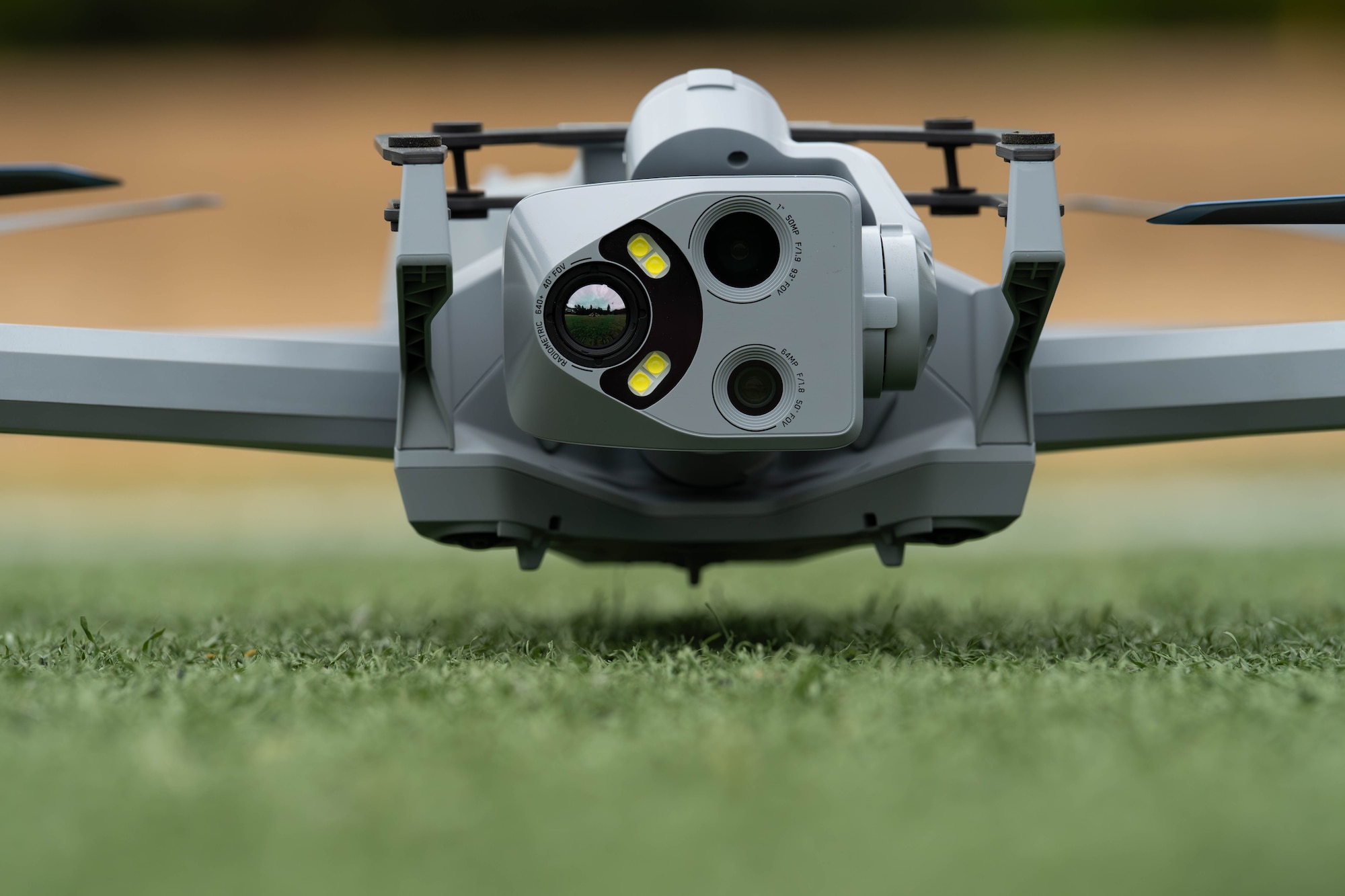 A drone on the ground with sensors forward.