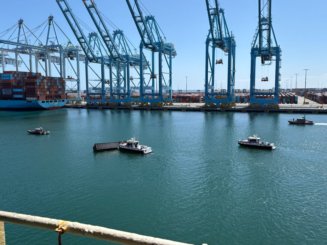 U.S. Coast Guard and Los Angeles Fire Department smallboats respond to and maintain a security zone around three 40-ft containers that fell off a ship during cargo operations in the Port of Los Angeles, September 14, 2026.