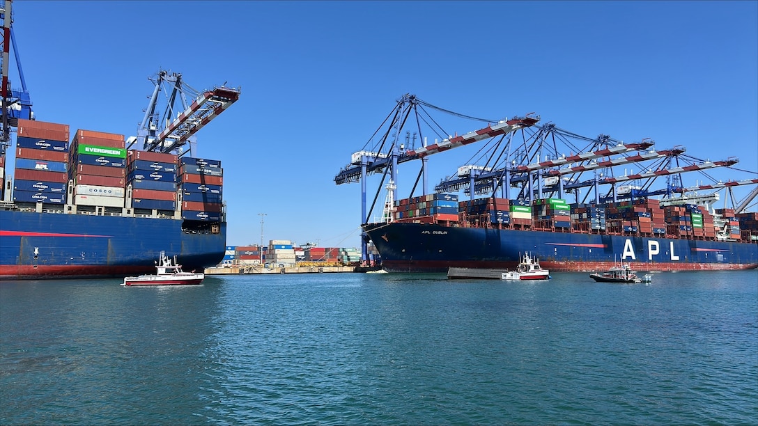 U.S. Coast Guard and Los Angeles Fire Department smallboats maintain a security zone around three 40-ft containers that fell off a ship during cargo operations in the Port of Los Angeles, September 14, 2026.