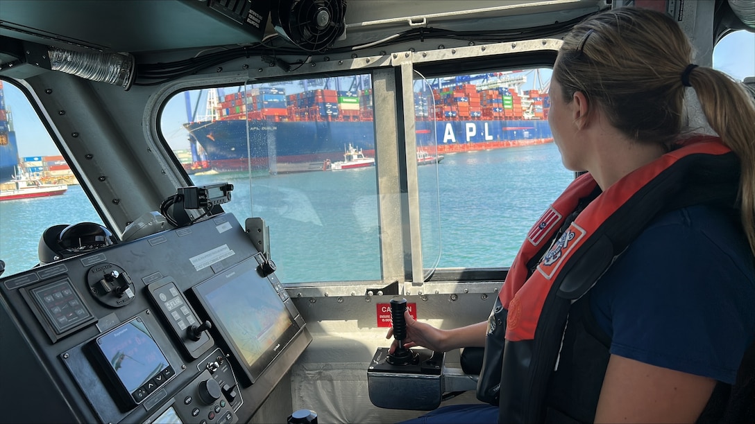 U.S. Coast Guard and Los Angeles Fire Department smallboats maintain the security zone around three 40-ft containers that fell off a ship during cargo operations in the Port of Los Angeles, September 14, 2026.