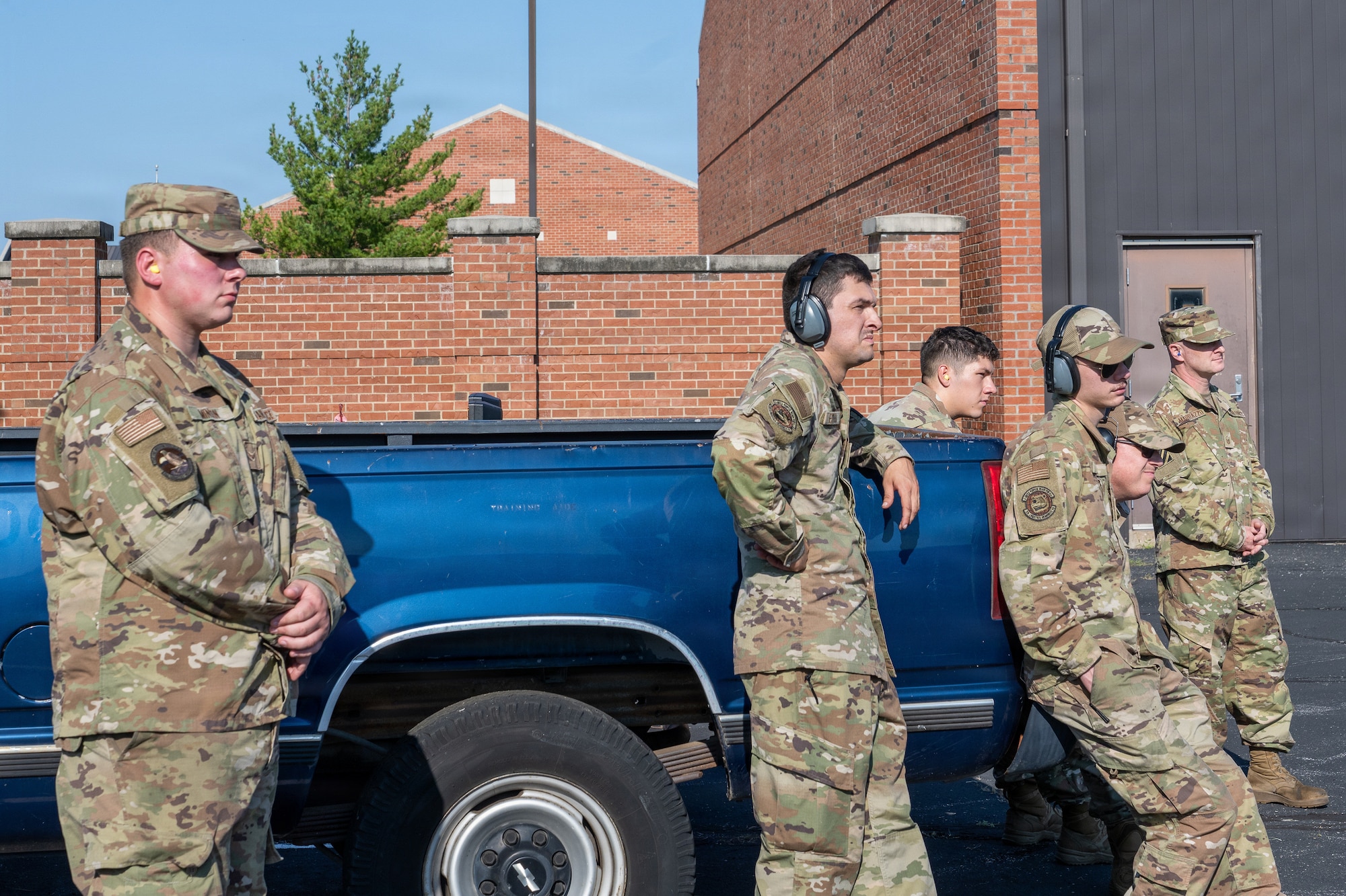 Several Airmen surround a truck watching deicer training.