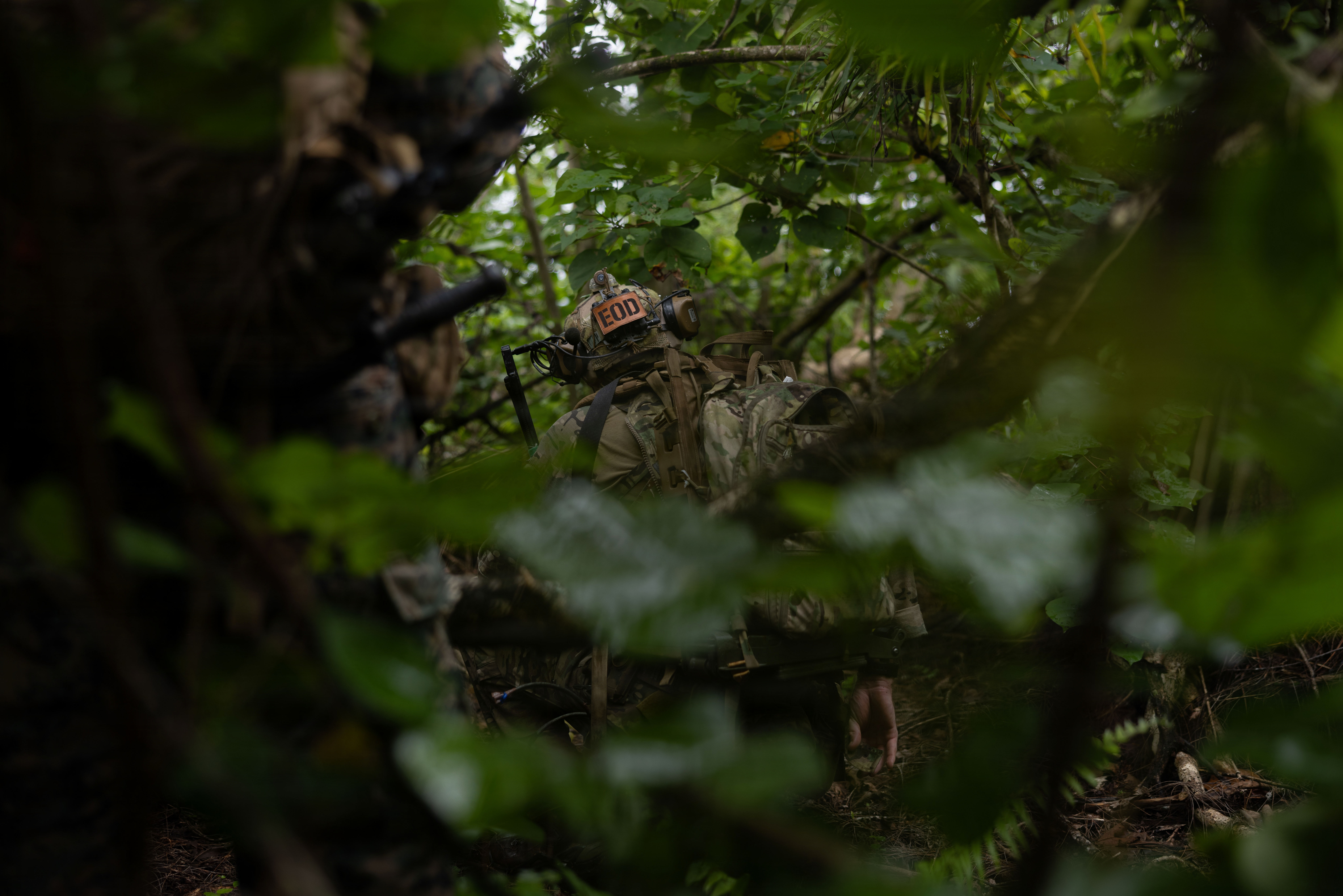 A U.S. Army explosive ordnance disposal technician squats down to map out the next target during joint force exercise Epic Crab 2026, at Skaggs Urban Training Complex, Marine Corps Base Camp Blaz, Guam, Sept. 1, 2026.  Epic Crab is a joint training exercise that enhances multinational and interservice interoperability, ensuring rapid response capabilities across the Indo-Pacific. (U.S. Marine Corps photo by Lance Cpl. Jayden Martinez)