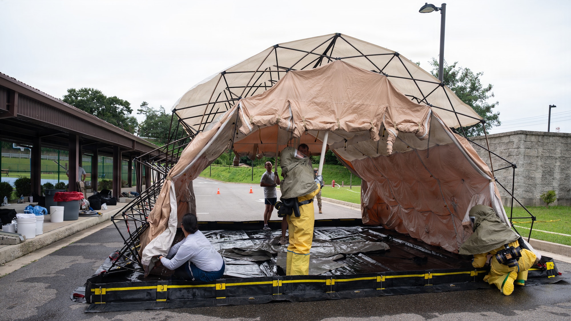 Medical personnel set up a mobile decontamination tent.